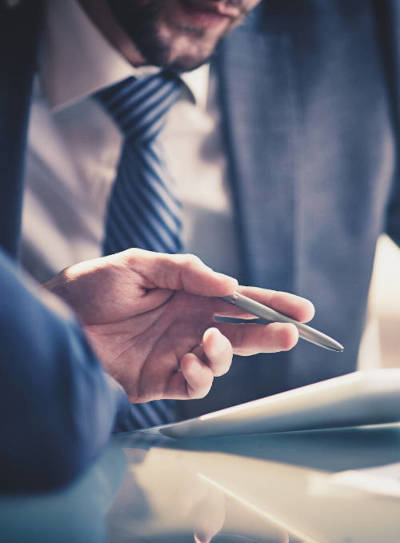 a picture of a man in a suit holding a pen